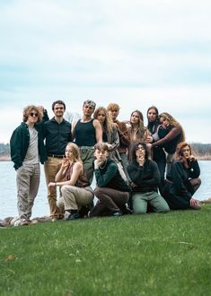 a group of people standing next to each other on top of a lush green field