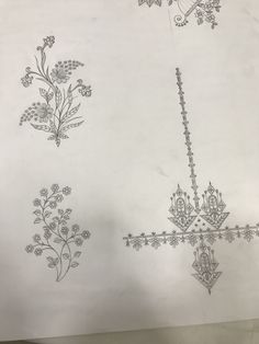 some drawings on paper with flowers and vines in them, one is drawn by hand