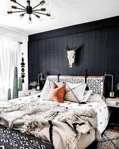 a black and white bedroom with an animal head on the wall