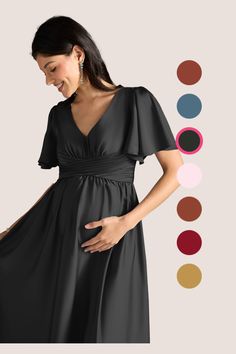 a pregnant woman in a black dress with her hands on her belly, standing next to color swatches