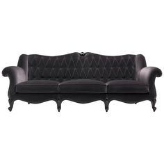 a black couch with an ornate design on the back and arms, sitting against a white background