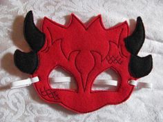 a red and black mask with horns on it