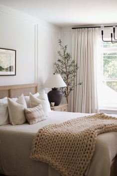 a bedroom with a large bed and white walls