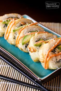 sushi rolls on a blue plate with chopsticks next to it and the words gobilla rolls