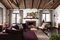 a living room filled with furniture and a fire place in the middle of a room