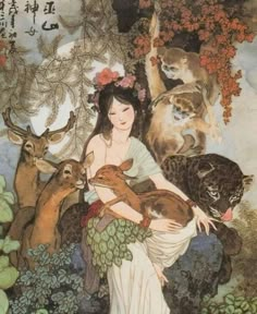 a woman holding two cats in her arms and surrounded by other animals on the ground