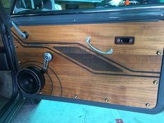 the interior of a car with wood paneling and metal trimmings on it