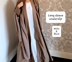 The perfect inner slip with long sleeves to style with any of our abayas. Each slip includes a belt too.  Material - soft touch Nidha (polyester)    Long sleeve - Black and half white. We also have a seperate listing for short sleeves.  https://www.etsy.com/listing/1352903192/abaya-slipunderslip-abaya-innerslip Please refer to the size guide in the images section.  No refunds/exchanges on this item. Elegant Long Beige Abaya, Modest Long White Thobe, Elegant Beige Long Thobe, Elegant Long Beige Thobe, Formal Long Solid Abaya, Elegant Fitted Long Abaya, Elegant Long Fitted Abaya, Elegant White Long Sleeve Abaya, Elegant Long White Abaya