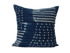 a blue and white pillow on a white background