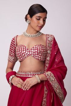 Red flared attached cancan lehenga with mirror hand embroidery. Paired with a padded mirror embroidered blouse and dupatta with mirror embroidered border. - Aza Fashions Red Fitted Sets With Mirror Work, Elegant Red Gota Work Choli, Fitted Red Choli With Gota Work, Elegant Red Choli With Gota Work, Fitted Sets With Motifs For Celebration, Mirror Lehenga, Vani Vats, Cancan Lehenga, Red Flare