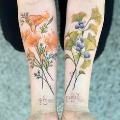 two matching tattoos with flowers on their arms