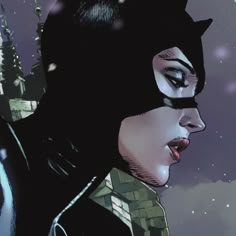 a woman in catwoman costume standing next to a castle with snow falling on her face