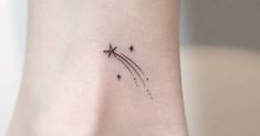 a small tattoo on the ankle of a woman with an airplane flying in the sky