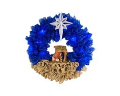 a blue wreath with a star on top and a nativity scene in the center