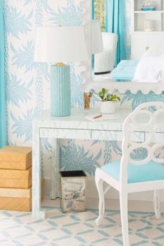 a white desk with a blue chair in front of it and a mirror on the wall