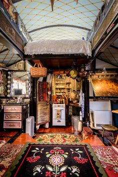 a room filled with lots of furniture and rugs