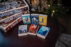 several books are sitting on a table with christmas decorations in the backgroung