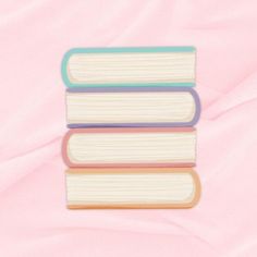 three books stacked on top of each other in the shape of a stack against a pink background