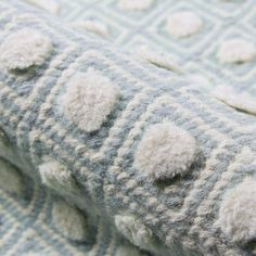 a close up view of a blanket with holes in it