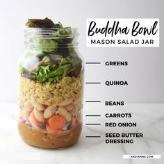 a mason jar filled with salad ingredients labeled in the words, build the boat salad greens quinoa beans carrots red onion seed butter dressing