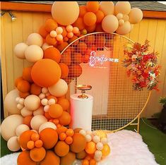 an orange and white balloon arch on display