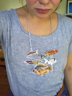 a woman wearing a necklace with fish on it