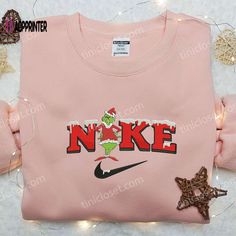 The Grinch Xmas x Nike Embroidered Sweatshirt is the perfect blend of holiday cheer and sporty style. Made with high-quality materials, this sweatshirt features an eye-catching embroidered design inspired by Nike. Its cozy and comfortable fit ensures warmth during the winter season. It makes for the best Christmas gift idea, offering a unique and trendy option for your loved ones. Let the Grinch and Nike bring joy and style to your festive celebrations! Discover Comfort with Our Unisex Heavy Shi Nike Inspired, Grinch Santa, Embroidered Apparel, Sweatshirt Nike, Maroon Hoodie, Nike Brand, Hoodie Material, Embroidered Sweatshirt, The Grinch