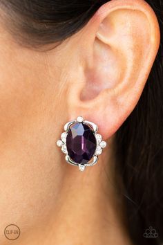 Sporadically dotted in sections of glassy white rhinestones, shimmery ribbons of silver gently fold around a dazzling purple emerald-style gem center for a regal look. Earring attaches to a standard clip-on fitting. Sold as one pair of clip-on earrings. P5CO-PRXX-022XX Color Uva, Paparazzi Accessories Jewelry, Emerald Style, Purple Gems, Earrings Trendy, Purple Earrings, Oval Earring, Paparazzi Accessories, White Rhinestone