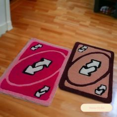 two rugs on the floor with arrows pointing in different directions, one pink and one red