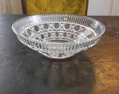 a glass bowl sitting on top of a wooden table