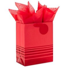 a red gift bag with tissue paper in it