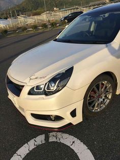 a white car parked in a parking lot