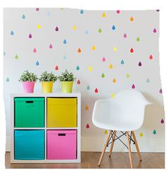 a white chair sitting in front of a colorful cabinet