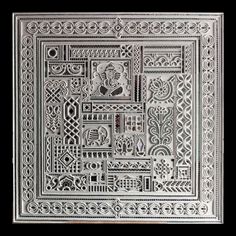 an intricately designed white tile with decorative designs