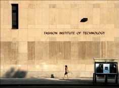 a woman walks past the fashion institute of technology