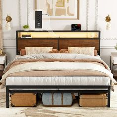 a bed with two suitcases underneath it in a room that has white walls and beige carpeting