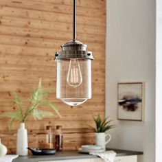 a glass light hanging over a kitchen counter