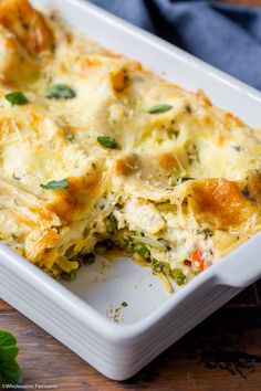 a casserole dish with broccoli, cheese and spinach in it