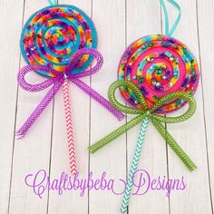 two colorful lollipops with ribbons on them