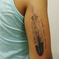 a person with a feather tattoo on their arm