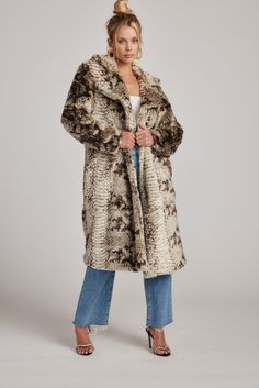 Channel your inner diva in the Vivienne Grey Snake Faux Fur Jacket. Designed with a warm snake print faux fur and a maxi length, this coat is keeping you warm, and more importantly so on trend! Please note due to the variation in fabric, print and placement of print can vary slightly. This is an oversized coat featuring pockets. STYLE RECOMMENDATIONS: - pair with the Dylan Jeans and Soho Beanie PRODUCT DESCRIPTION AND MATERIALS: - grey snake faux fur jacket - front button closure - functional side pockets - lined - 100% polyester - machine wash cold - hang to dry SIZE RECOMMENDATIONS: - runs oversized - measured on a size small Small: 2-4 - length: 43" - sleeves: 22.25" Medium: 4-6 - length: 43.75" - sleeves: 22.5" Large: 8-10 - length: 44" - sleeves: 23" MODEL DETAILS: - Paige is 5'8 - Bu Fall Snake Print Long Sleeve Outerwear, Fall Long Sleeve Snake Print Outerwear, Luxury Winter Snake Print Outerwear, Long Sleeve Snake Print Winter Outerwear, Leopard Print Fur Coat With Faux Fur Trim, Faux Fur Leopard Coat, The Vivienne, Oversized Coat, Fabric Print