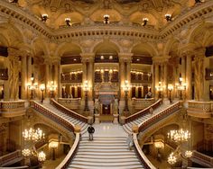 an image of the staircases and chandeliers in a building with lights on them