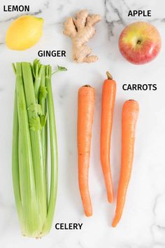 carrots, apples, celery, lemon, ginger, ginger, ginger juice and other vegetables on a marble counter top