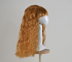 WILLOW Size: 4-5 Wig length from top to bottom: 4 1/2" Color: dark golden blonde Type: synthetic mohair This long wig is wavy, with a middle part, and bangs Dark Golden Blonde, Doll Wig, Doll Wigs, Golden Blonde, Middle Part, Middle Parts, Long Wigs, Doll Parts, Halloween Shopping