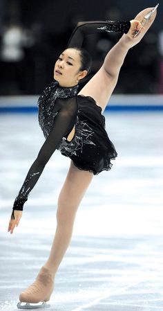 a female figure skating on an ice rink