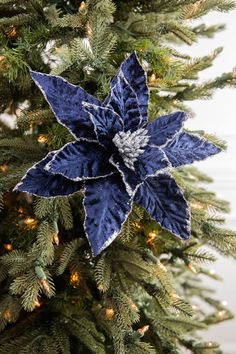 a blue and white christmas ornament on top of a tree