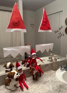 two elfs are sitting in front of the bathroom mirror