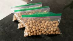 three bags filled with peanuts sitting on top of a counter