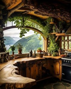 a kitchen with an oven, sink and window overlooking the mountains is shown in this image