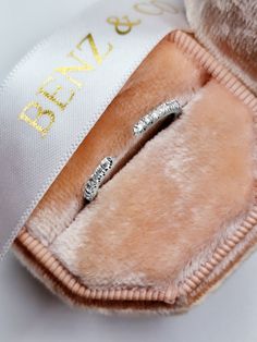 two diamond wedding rings in a pink velvet case